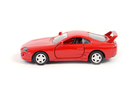 Red sport toy car on white background の写真素材