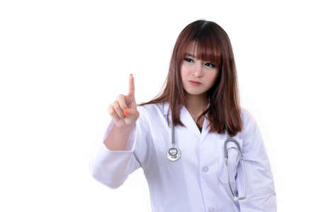 Female doctor point her finger to something on white background.の写真素材