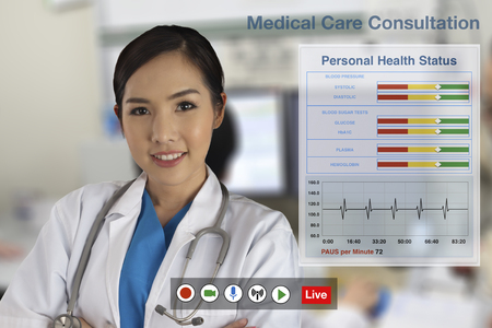 Doctors are currently providing medical consultation to patients through the computerized distance service.の写真素材