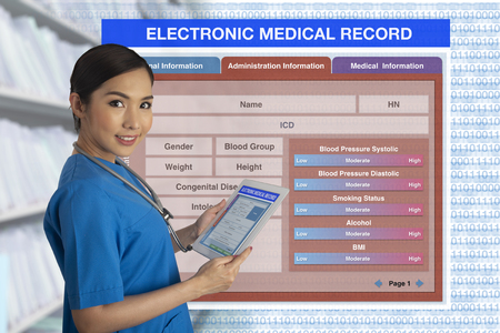 Female doctor holding tablet that showing medical record form in hands with blank electronic medical record form on background.の写真素材