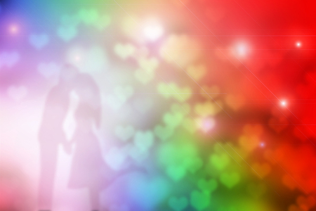 Shadow of lovely couple kissing with colorful heart bokeh for valentine background.の写真素材
