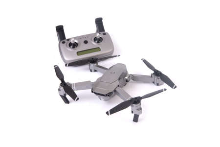 Small drone with remote control on white background.