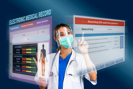 Female doctor searching disease code while work on electronic medical record that display as holographic images on blue background.の写真素材