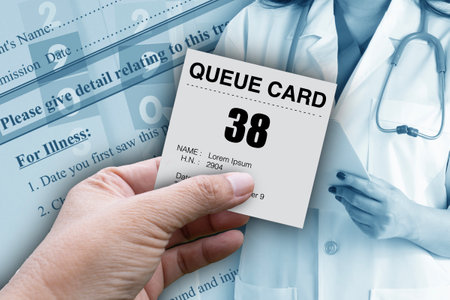 Hand holding queue card for patient who waiting in line for medical treatment.の写真素材