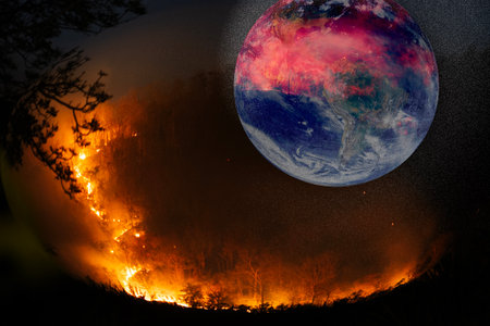 Forest fire on earth with the planet globe burned by fire.の写真素材