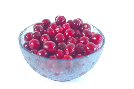 Red berry in blue transparent Cup isolated on white background