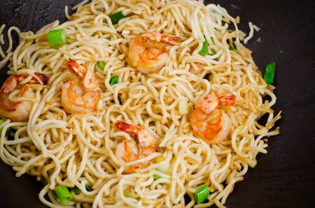 Stir-fried noodle with shrimp in a wok panの写真素材