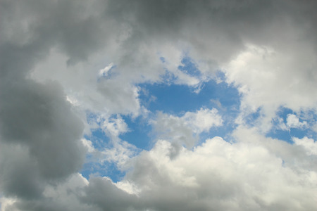 Blue sky with black cloudsの写真素材