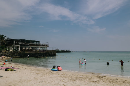 Jeju Island, South Korea - July 10, 2022: Many people are splash at hamdeok beach in summer, Jeju Island, South Korea.のeditorial素材