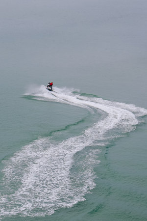 Man speeding on jet ski on the sea during summer in Jeju island, South Korea.の写真素材