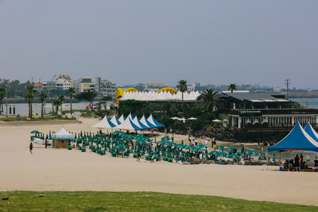 Jeju Island, South Korea - July 10, 2022: The lined parasols on Hamdeok Beach, Jeju Island.のeditorial素材