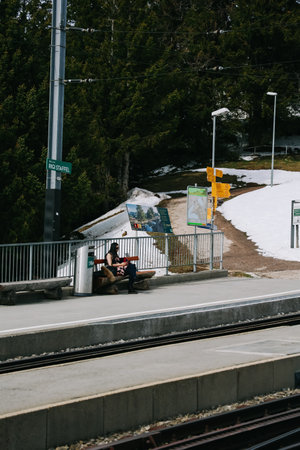 Rigi, Switzerland - April 12, 2022: A woman is waiting the train to Arth city at Rigi Staffel station.のeditorial素材