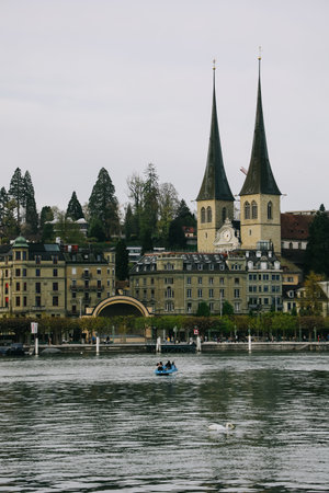 Luzern, Switzerland - April 12, 2022: View of Church of St. Leodegar or Hofkirche St. Leodegar Lucerne lakefront, this is a Roman Catholic church in the city of Lucerne, Switzerland.のeditorial素材