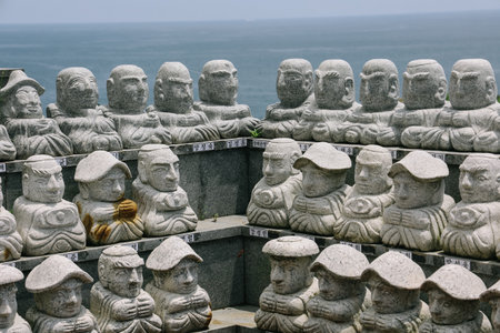 Jeju Island, South Korea - July 12, 2022: Buddha sculptures lined up in a row at Sanbanggulsa temple in Jeju Island, South Korea.のeditorial素材