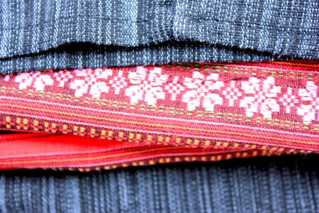 Pink flower in red black pattern background in Thai Sarong