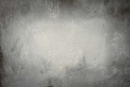 Image of cement wall old gray grunge with a rough texture and different decorative patterns. There are vignettes and the center of the image is bright. The idea for vintage background with copy space.の写真素材
