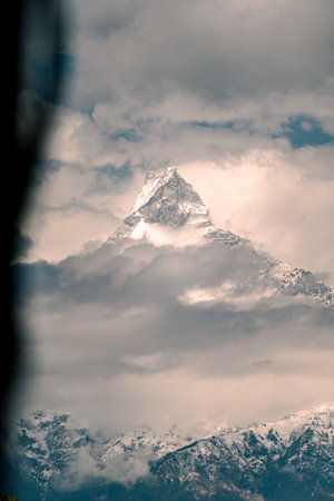 The front view of a snow-covered peak in winter. Clear sky on a sunny and chilly day. The idea for a soft-toned nature background with copy space.の写真素材