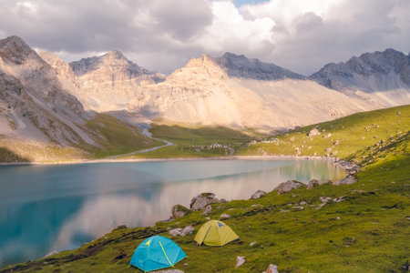 The front view of Tientang Hu lake, Xinjiang, China. There are many mountains in the background. The...