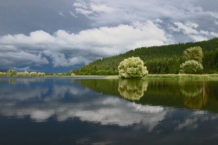 Stormy reflections on lakeの写真素材