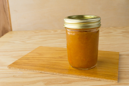 Homemade pine mango jam on wood backgroundの写真素材