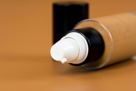 bottle of liquid foundation on brown background./ liquid foundation.