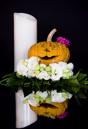 Halloween pumpkin with white and pink rode on black Halloween.の写真素材