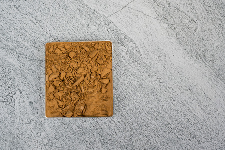 Compact powder on stone texture background./ Compact powder.