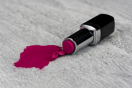 Pink lipstick and lipstick smear on stone texture background./ Lipstickの写真素材