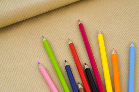 Colorful pencils on brown paper backgroundの写真素材