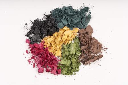 Pink, green, gold, blue, beige color of eyeshadow powder on white backgroundの写真素材