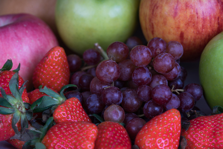 multiple fruits include apple, strawberry, grapesの写真素材
