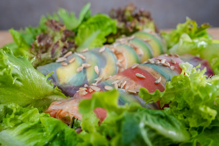 Close up of fresh spring rolls with lettuce, tomatoes and sesame seedsの写真素材