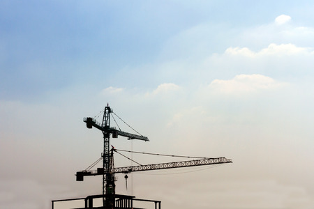 Industrial construction cranes silhouettesの写真素材