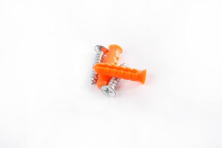 Orange color Plastic cleat  and screw on whiteの写真素材