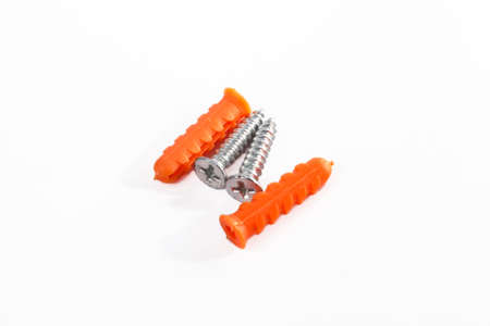 Orange color Plastic cleat  and screw on whiteの写真素材