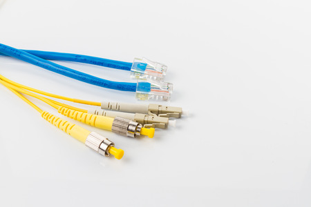 Close up of a fiber optic patchcord head and UTP LAN cable head