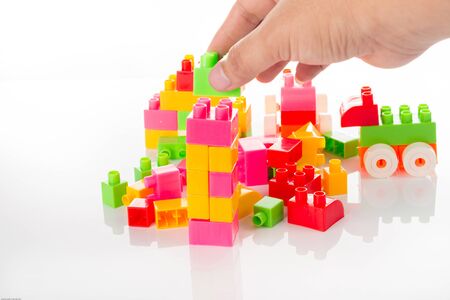 Colorful Toy Blocks with hand Isolated on White Background.の写真素材