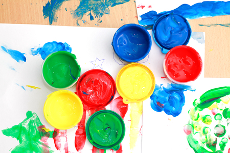 colorful finger paints on a tableの写真素材