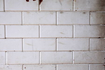 Close up of grunge white brick wall backgroundの写真素材