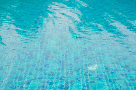 Blue ripped water in swimming pool, rain drop into swimming pool.の写真素材