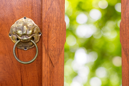 Chinese Traditional Wooden Door Opening, green bokhe of nature background.の写真素材