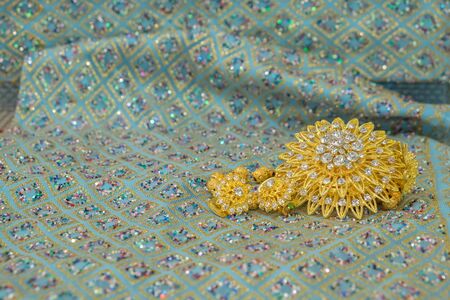Golden jewelry on  elegance fabricの写真素材