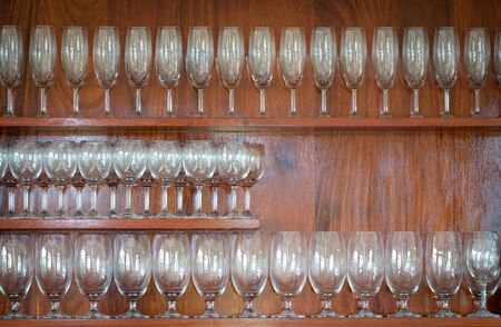 row of wine glasses, wooden background.の写真素材