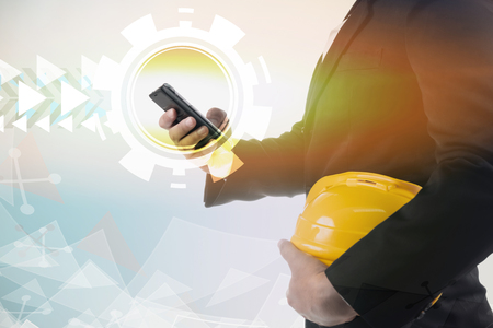 An engineer using mobile smart phone. Wireless mobile technology concept.の写真素材