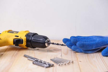 Close up yellow power drill on wooden. Do it your self concept.の写真素材