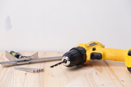 Close up yellow power drill on wooden. Do it your self concept.の写真素材