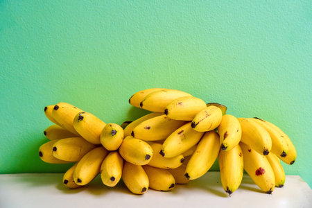 Bundle of Lady Finger Bananas Lying on a Shelfの写真素材
