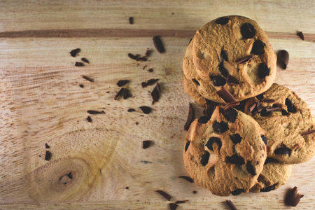 Chocolate chip cookies on wooden table - selective focus