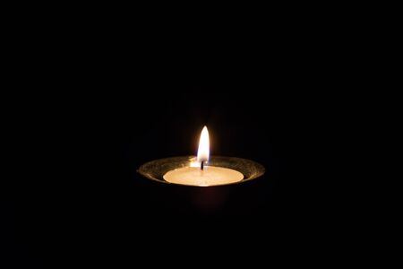 Candle in dark room