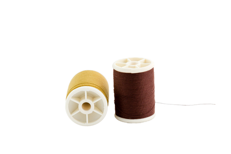 Brown and gold thread on white background